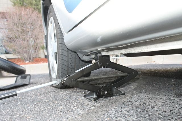 Jack located at lift point and raised enough to be steady, but leave the tire on the ground.
