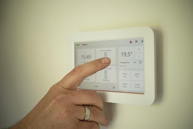 A person using their home's thermostat