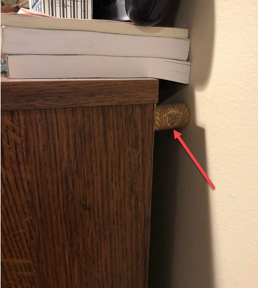Cork buffer holding PC armoire away from the wall