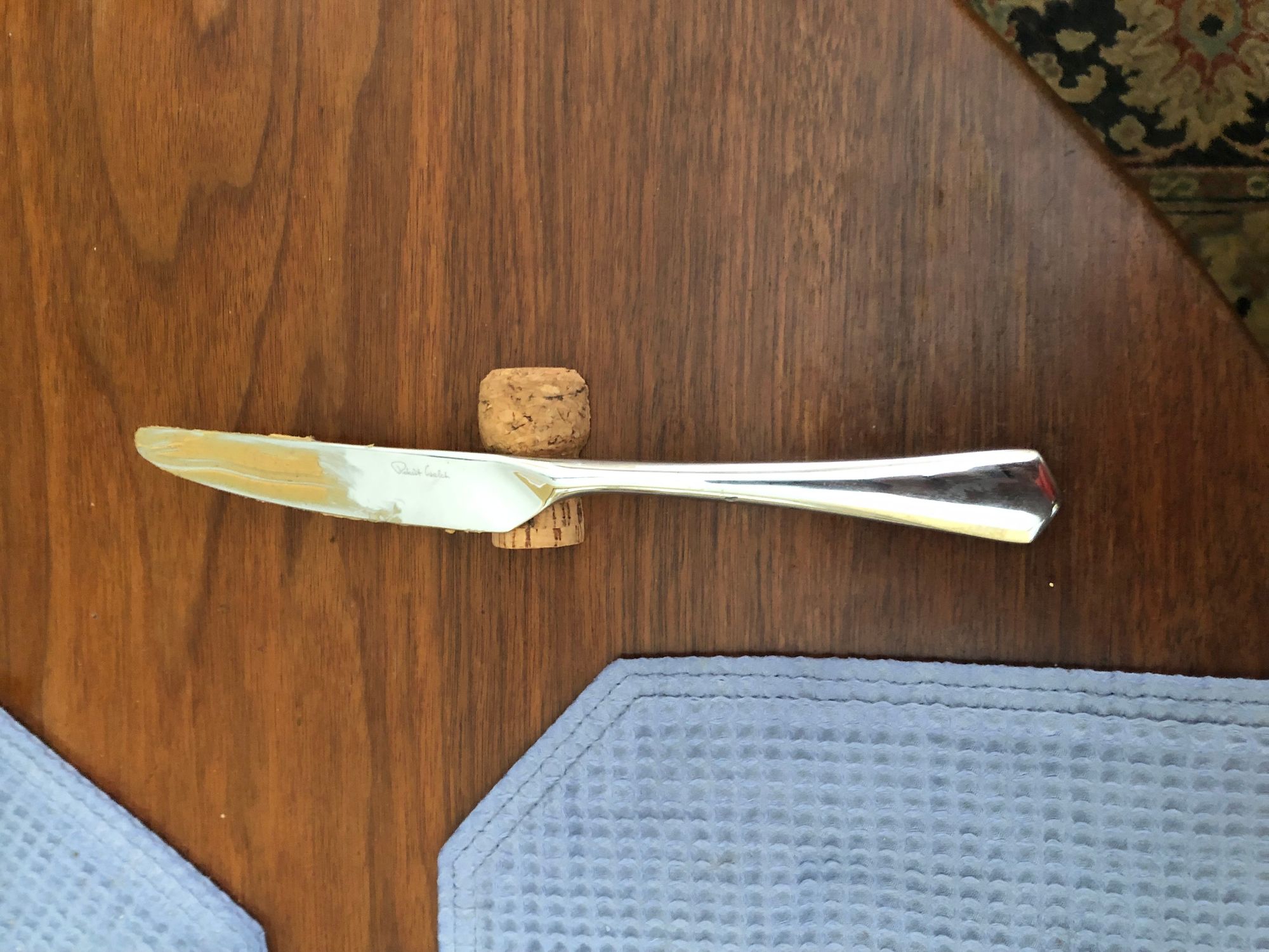 Picture of keeping peanut butter off the placemats with champagne cork knife rest.