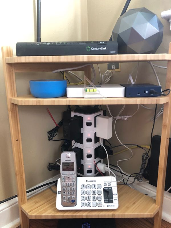 Home networking gear on IKEA Ragrund corner shelving unit with Sugru supported center shelf.