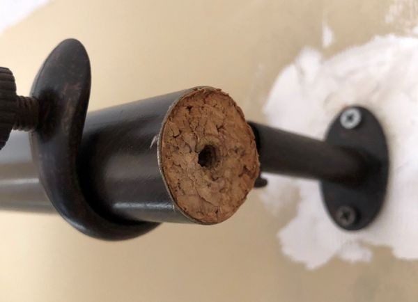 Drapery rod with cork replacement for the OEM spring threaded tube insert.