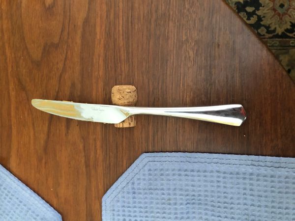 Picture of keeping peanut butter off the placemats with champagne cork knife rest.